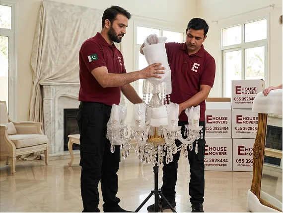 E House Mover Team Carefully Packing Chandelier for Moving