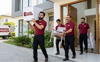 E House Mover Team Carrying Boxes During Home Relocation