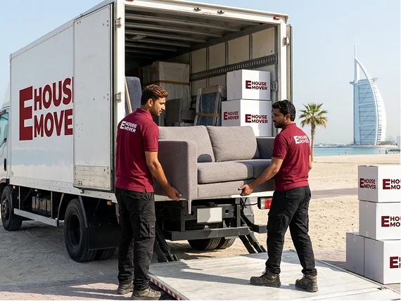 E House Mover Team Loading Sofa into Moving Truck