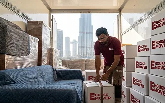 E House Mover Team Organizing Furniture Inside Moving Truck
