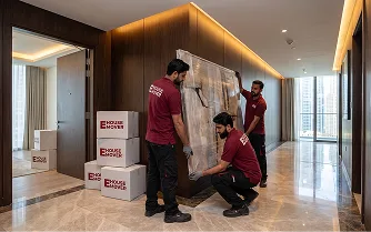 E House Mover Team Wrapping Furniture for Safe Relocation