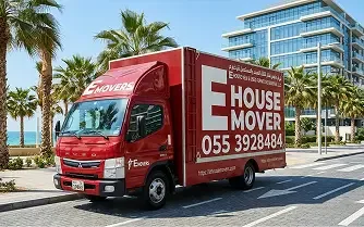 E House Mover moving truck driving through a residential area in Dubai.