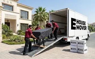 E House Mover team loading protected furniture into a moving truck during a villa move in Dubai.