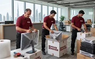E House Mover team packing office equipment in Dubai.