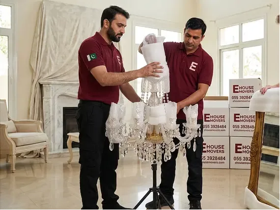 E House Movers Team Safely Packing a Crystal Chandelier for Relocation