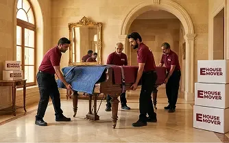 Movers carefully handling antique furniture during a luxury home relocation in Dubai.