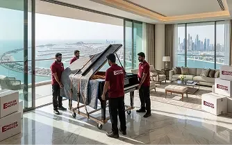 Movers carefully relocating a piano inside a luxury Dubai apartment.