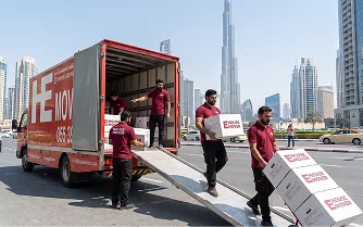 Movers unloading boxes from a truck near Burj Khalifa Dubai.