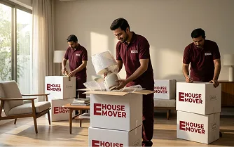 A crew member lifting items from an office into an open carton