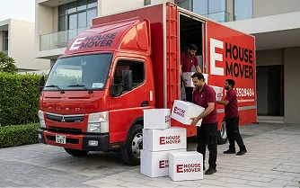 E House Mover UAE team in Dubai loading boxes on trucks
